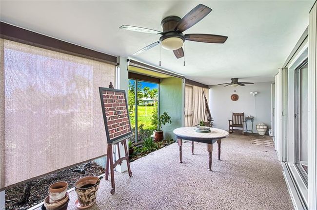 Sunroom / solarium with a ceiling fan | Image 20