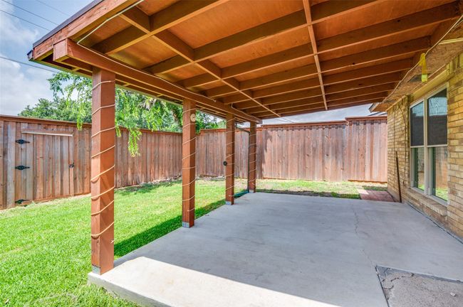 Fenced backyard featuring a patio area | Image 4