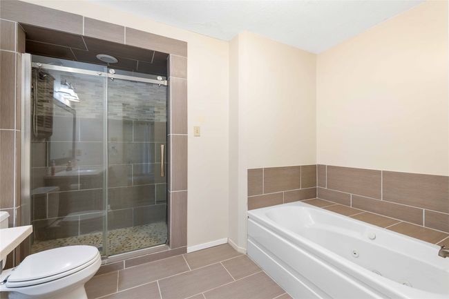 Primary bathroom with separate walk in shower and a jetted tub | Image 20