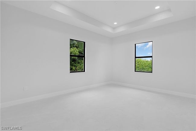 Empty room featuring a healthy amount of sunlight and a raised ceiling | Image 37