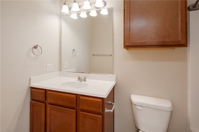 Bathroom featuring toilet and vanity | Image 9