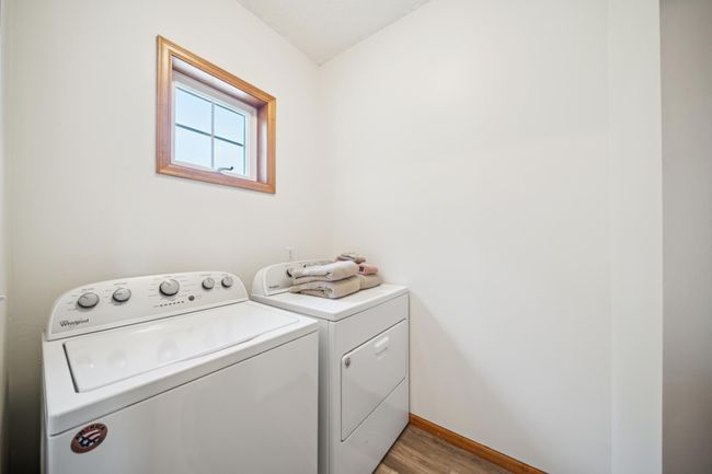 Upstairs are three bedrooms, including a spacious primary suite and laundry. | Image 24