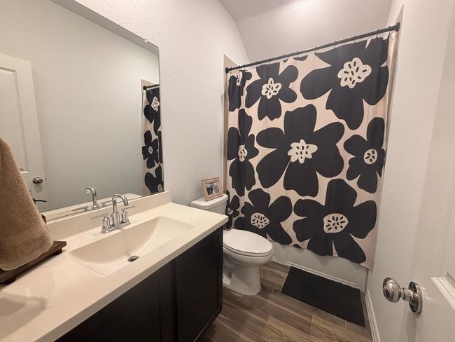 Bathroom featuring vanity, wood finished floors, and curtained shower | Image 19
