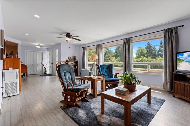 Living area with a ceiling fan, light wood-type flooring, and recessed lighting | Image 15