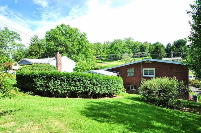 This shed is tucked away in the front yard. Great storage for lawn mower & garden tools. | Image 44