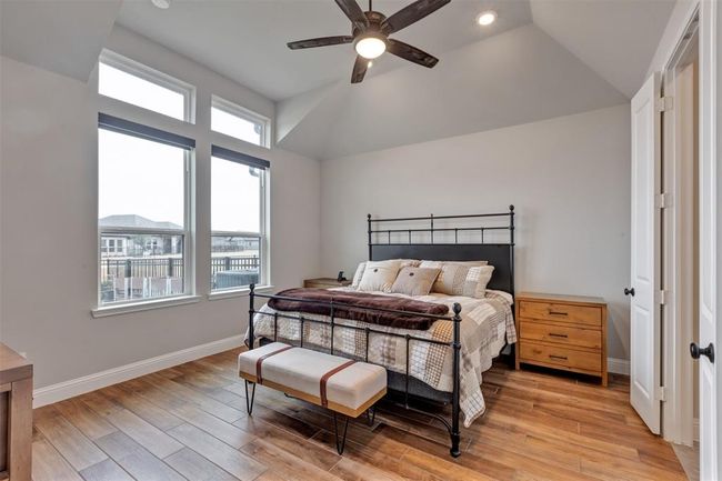Primary bedroom with large windows to back yard | Image 12