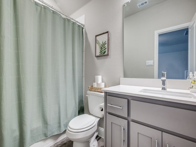 Guest bath with a quartz vanity and a shower-tub combo! | Image 22