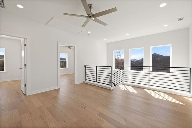Unfurnished room featuring attic access, light wood flooring, visible vents, and recessed lighting | Image 17