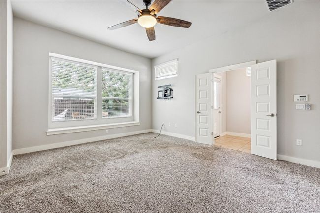 Unfurnished bedroom with light carpet, multiple windows, and baseboards | Image 17