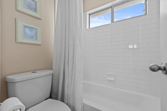 Bright, fresh, and beautifully updated, this secondary bathroom features a double vanity and timeless finishes. | Image 26