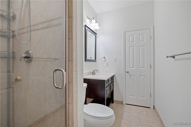 Basement bath with vanity and a stall shower | Image 48