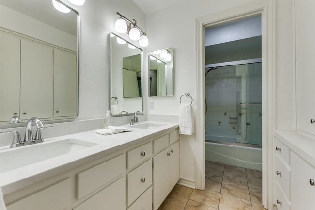 Hall bath has double sinks and a large wall of cabinets. The new quartz continues in this bath. | Image 15