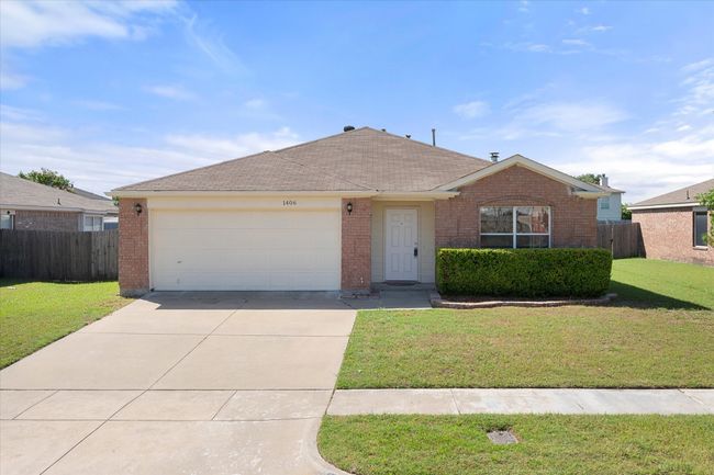 Single story home with brick siding, driveway, a garage, and roof with shingles | Image 18