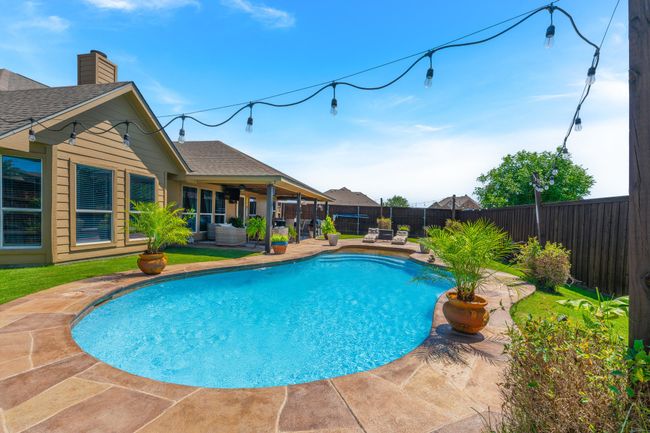 View of pool featuring a patio area and a fenced backyard | Image 36