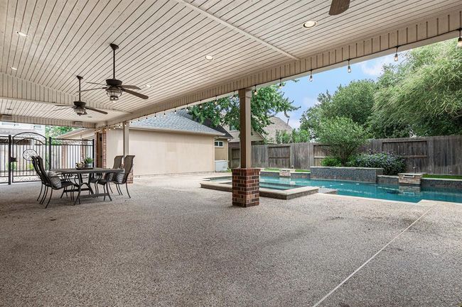 The patio overlooks the fabulous outdoor oasis, complete with pool & spa for the ultimate backyard vacation. | Image 38