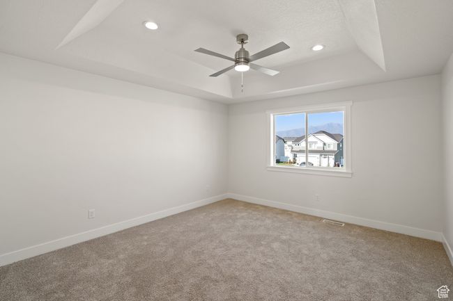 Spare room with a raised ceiling, light carpet, recessed lighting, and a ceiling fan | Image 17