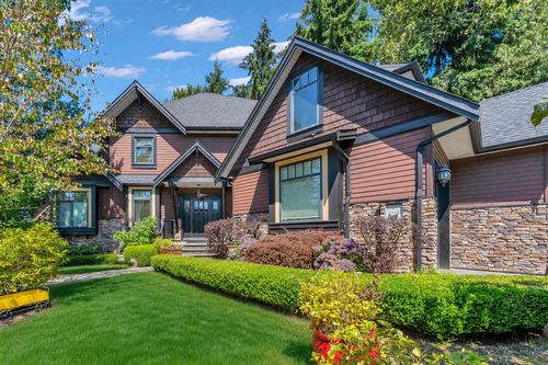 Craftsman-style architecture featuring shingle siding and stone accents | Card Image