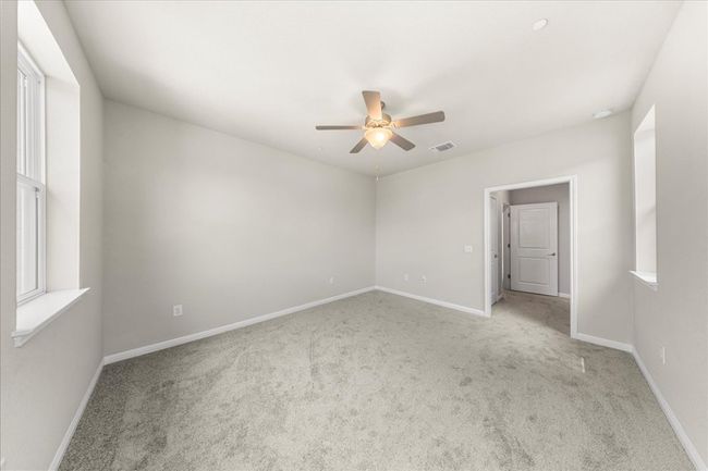 Spare room featuring ceiling fan, carpet floors, and baseboards | Image 26