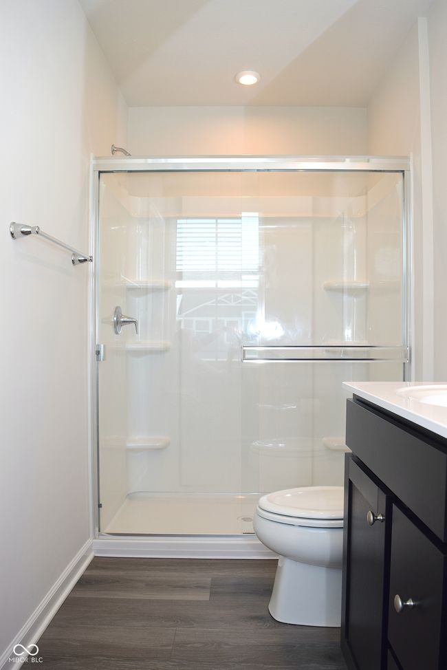 primary bathroom with walk-in shower and laminate flooring | Image 28