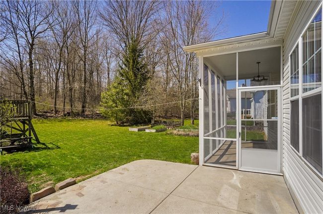 View of yard featuring a sunroom and a patio | Image 45