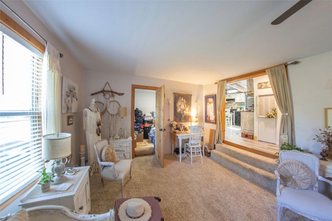 Living room featuring light carpet and ceiling fan | Image 13