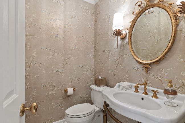 Updated powder bath with gold toned framed mirror and fixtures | Image 8