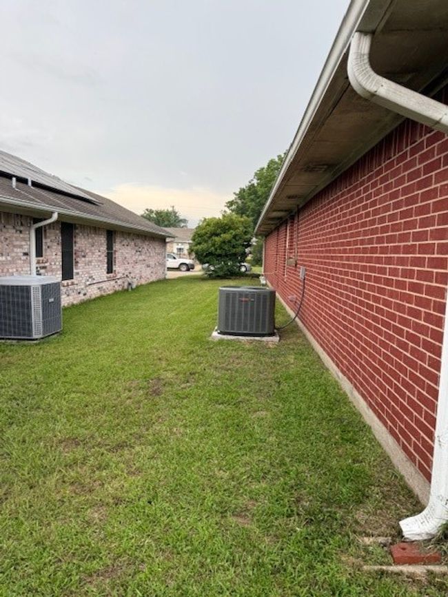 View of green lawn featuring central AC unit | Image 9