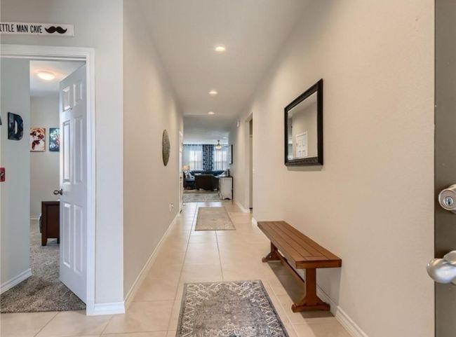 Hall with light tile patterned flooring and recessed lighting | Image 5