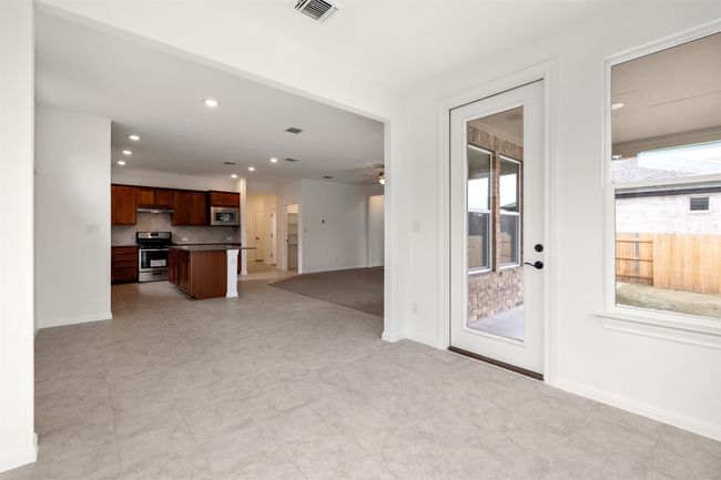 View from dining room to kitchen and family room. | Image 7