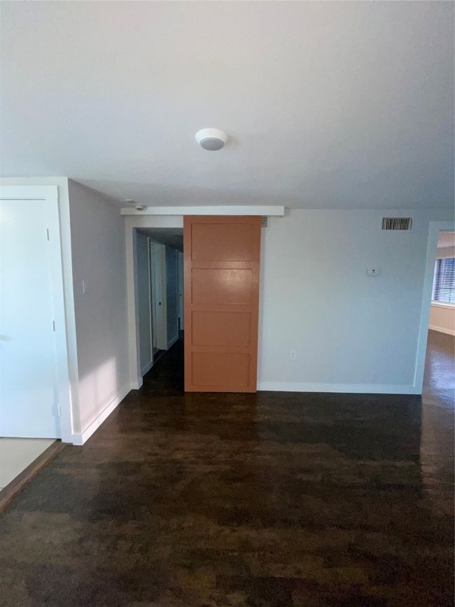 Spare room featuring baseboards and dark wood-style flooring | Image 17