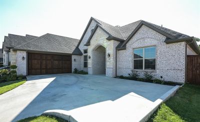 French country style house with a 2-car garage | Image 3