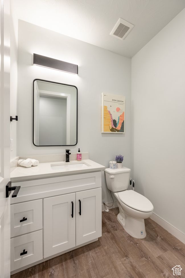 Bathroom with wood-type flooring, toilet, and vanity | Image 42