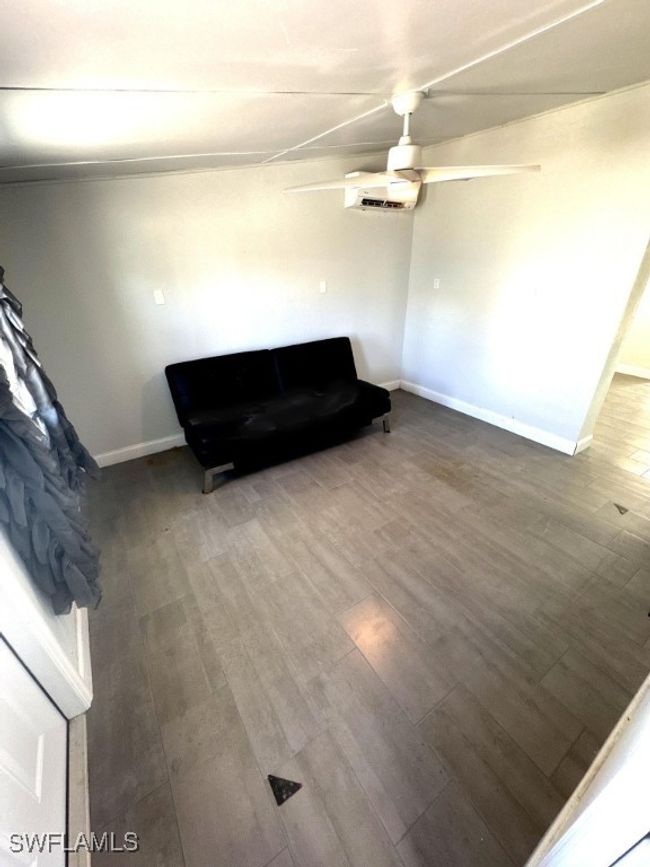 Unfurnished room with wood finished floors, baseboards, and ceiling fan | Image 13