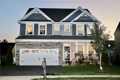 Craftsman-style house featuring a yard, a porch, and a garage | Image 2