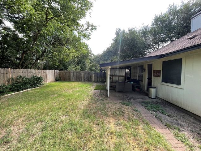 Fenced backyard with an outdoor hangout area and a patio area | Image 9