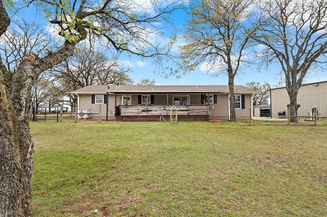 Rear view of property with roof with shingles, fence, and a yard | Image 44