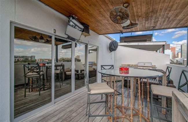 On the rooftop deck, enjoy grilling sports watching, and downtown views! There is also a large storage closet to store cushions or other items you don't want to leave outside. | Image 34