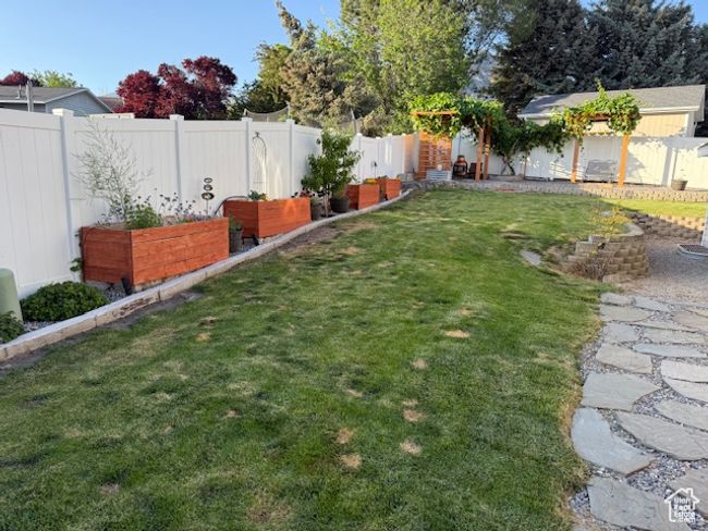 Fenced backyard with a vegetable garden | Image 46
