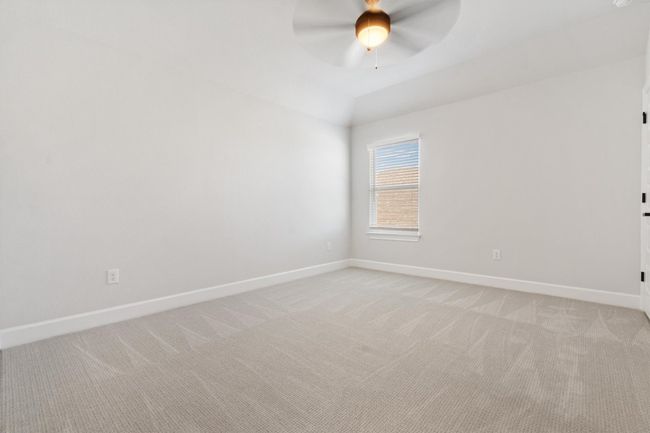 Spare room with baseboards, light colored carpet, ceiling fan, and vaulted ceiling | Image 21