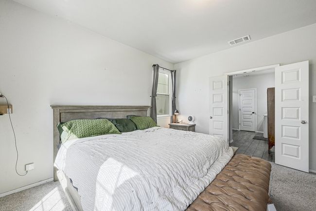 Frech doors lead to the spacious primary bathroom. | Image 15
