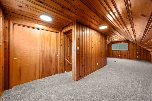 Additional living space with lofted ceiling, wooden walls, carpet flooring, and wooden ceiling | Image 28