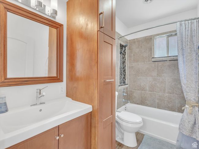 Full bath featuring toilet, vanity, and shower / bathtub combination with curtain | Image 33