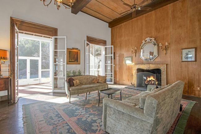 Living room featuring hardwood / wood-style flooring, wood walls, wooden ceiling, ceiling fan, and beam ceiling | Image 8