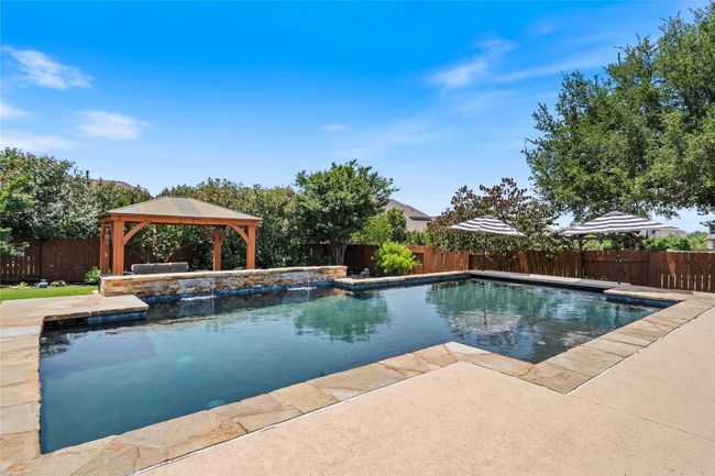 Backyard Oasis with Sparkling Pool, Pergola, and Outdoor Kitchen | Image 5
