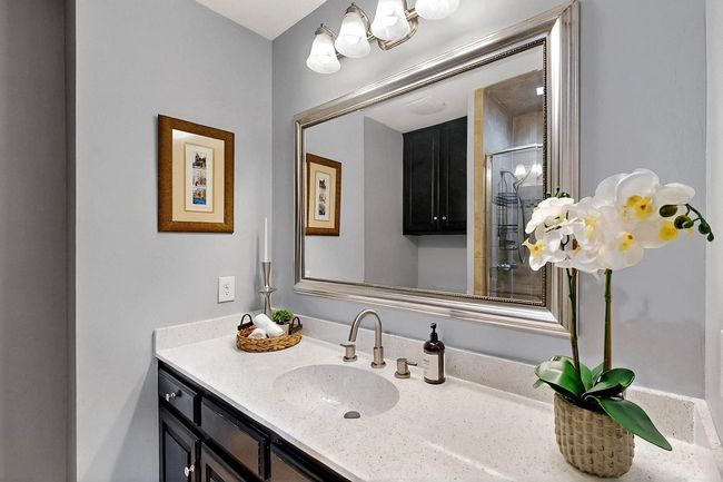 Bathroom with vanity and a shower with door | Image 25