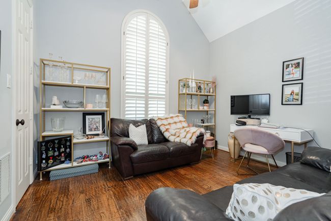 Living room featuring wood finished floors and high vaulted ceiling | Image 15