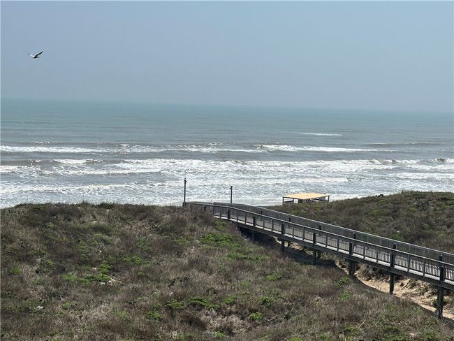 Enhanced balcony view of ocean and beach walkover. | Image 38