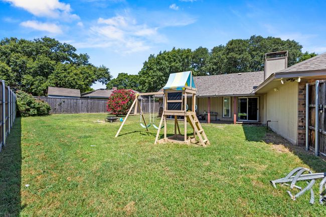 Fenced backyard featuring a playground | Image 27