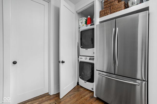 washroom with stacked washing machine and dryer | Image 22