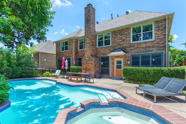 View of swimming pool featuring a pool with connected hot tub | Image 32